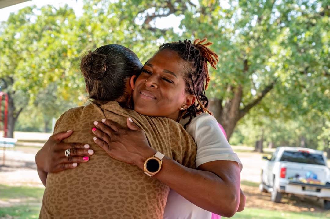 LaWanda Crawford embracing another person outdoors