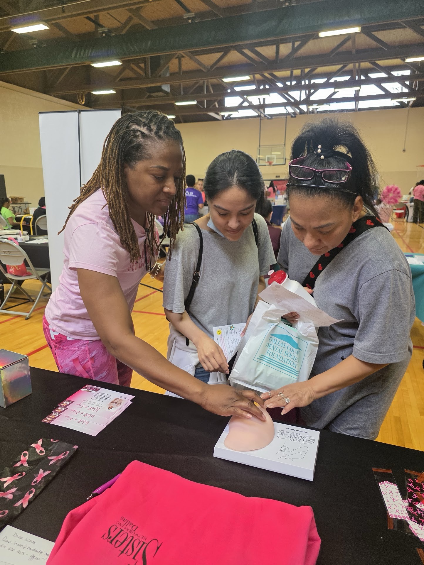 LaWanda Crawford guiding two people at an educational demonstration table